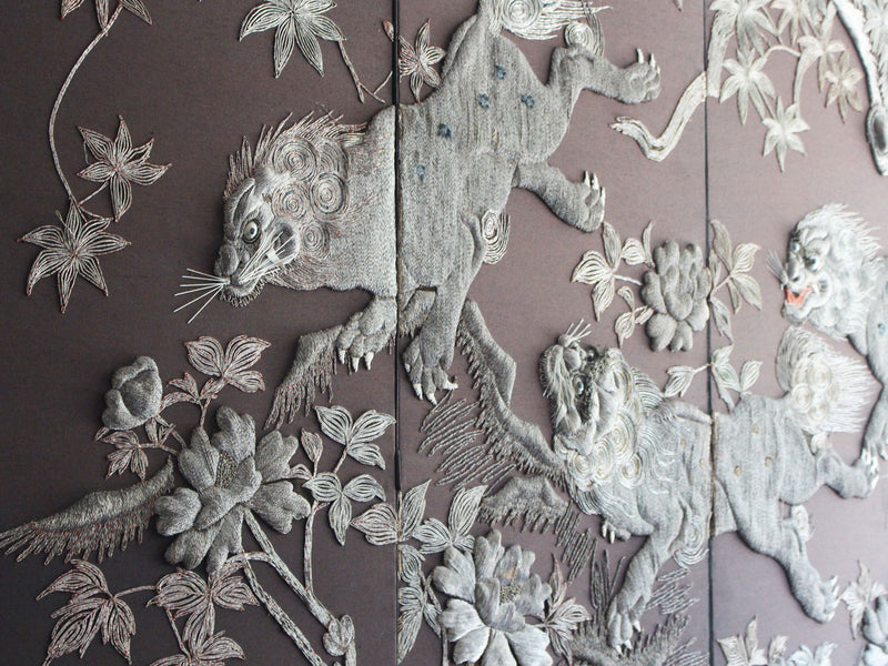 A Meiji Period Silverwork Embroidered Four Panel Screen Depicting Mythical Shishi
