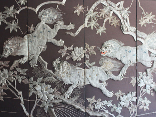 A Meiji Period Silverwork Embroidered Four Panel Screen Depicting Mythical Shishi