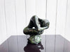 A Bronze Sculpture of a Crouching Woman