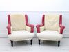A pair of antique French scroll back armchairs