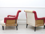 A pair of antique French scroll back armchairs