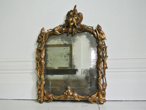 A Fantastical Italian Giltwood Mirror with Original Plate