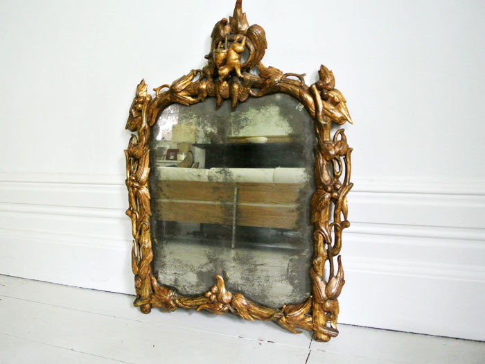 A Fantastical Italian Giltwood Mirror with Original Plate