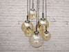 A 1970's French Pendant Light with Seven Pale Gold Glass Shades