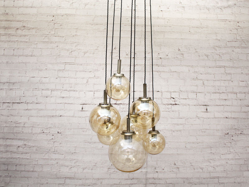 A 1970's French Pendant Light with Seven Pale Gold Glass Shades