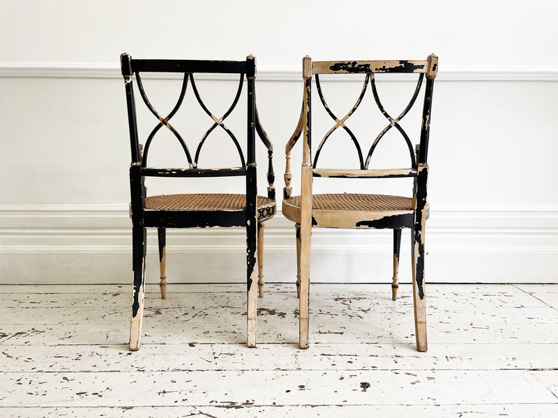 A Pair of Black Hepplewhite Caned Armchairs