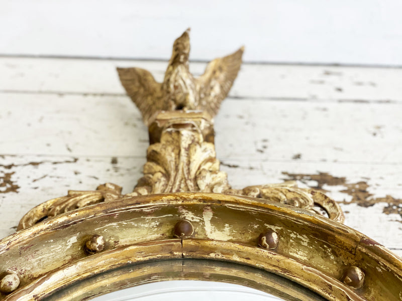 A Pair of 1920's Regency Style Gilt Wood Convex Mirrors with Carved Eagles