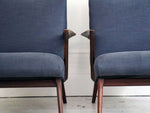 A pair of 1950's rosewood armchairs in the style of Poul Jensen