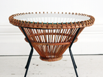 A 1950's rattan table with glass top on tripod legs by Franco Albini