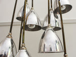 A Set of 9 Chrome Pendant Lights with Brass Stems & Silver Bulbs