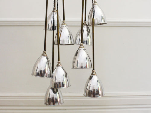 A Set of 9 Chrome Pendant Lights with Brass Stems & Silver Bulbs