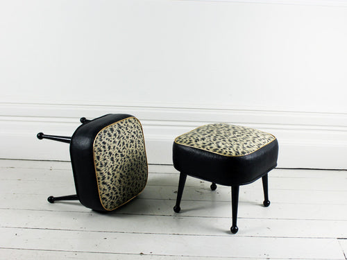 A pair of 1960's animal print black and gold footstools