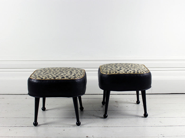 A pair of 1960's animal print black and gold footstools