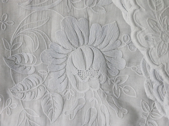 A pair of ornate French Cornely embroidered voile curtains