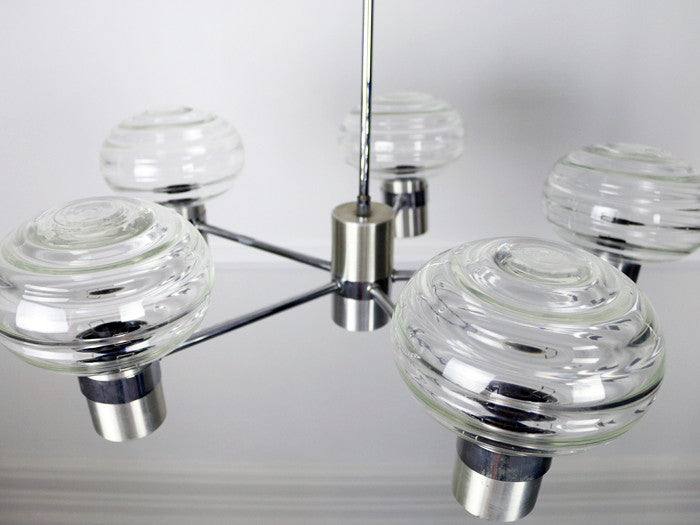 A 1970's French steel and glass five headed chandelier