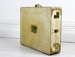 A Vellum Suitcase with Interior Hanging & Wing Shaped Handle Mounts