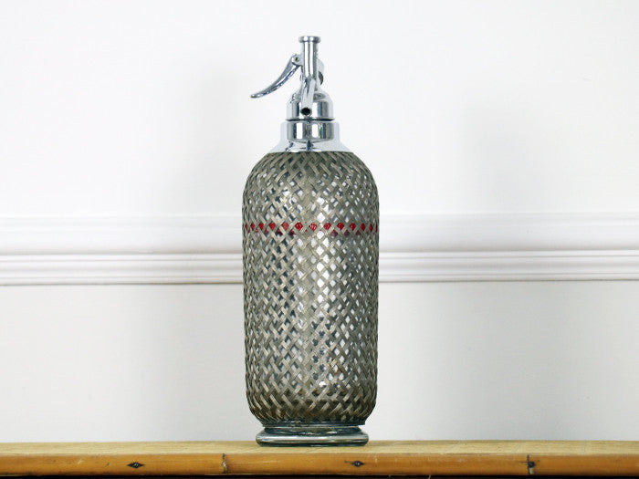 A 1950's wire mesh soda siphon